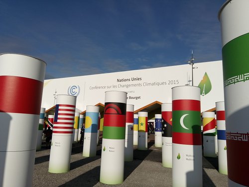 Entrance display featuring national flags displayed on wide and tall posts